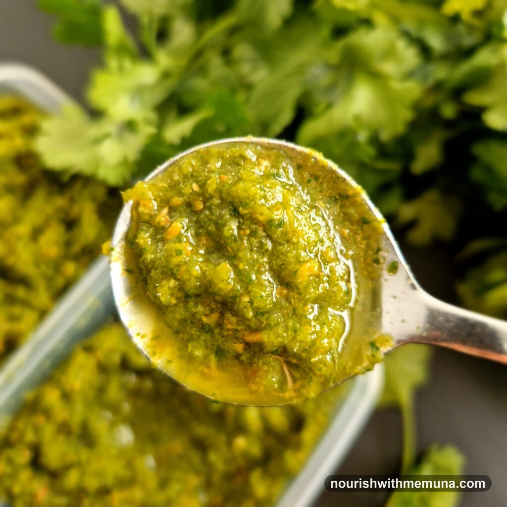 Spoonful of homemade green lila masala paste with fresh coriander
